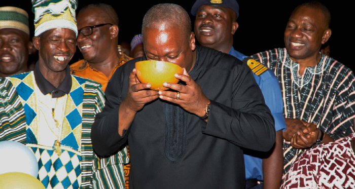 President Mahama fetching water from one of the standpipes to officially inaugurate the water project at Welembele. Right: President Mahama taking a sip after the inauguration 